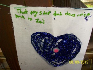 Camper's art project says, "That my step dad does not go back to Jail"